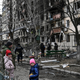 Children stand in front of a destroyed apartment building following Russian shelling in the northwestern Obolon district of Kyiv, Ukraine on March 14, 2022.